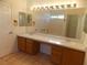 Bathroom with large mirror above vanity with double sinks and drawers at 1018 Sun Poppy Ave, Las Vegas, NV 89123