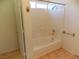 Bathroom featuring a bathtub and shower with ceramic tile surround at 1018 Sun Poppy Ave, Las Vegas, NV 89123