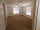 Bright bedroom featuring neutral carpet, two windows, and a ceiling fan at 1018 Sun Poppy Ave, Las Vegas, NV 89123