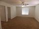 Spacious bedroom with plush carpeting, a ceiling fan, and natural light from a large window at 1018 Sun Poppy Ave, Las Vegas, NV 89123