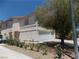 The side of this two story home has a two-car garage and desert landscaping at 1018 Sun Poppy Ave, Las Vegas, NV 89123