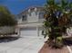 Spacious three car garage and long driveway framed by desert landscaping provide ample parking at 1018 Sun Poppy Ave, Las Vegas, NV 89123