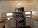 Modern kitchen with stainless steel appliances, granite countertops, and white cabinetry at 1018 Sun Poppy Ave, Las Vegas, NV 89123