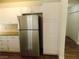 Galley kitchen with stainless steel refrigerator and matching white appliances and cabinets at 1018 Sun Poppy Ave, Las Vegas, NV 89123
