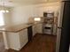 Modern kitchen features stainless steel appliances, granite countertops, and wood look floors at 1018 Sun Poppy Ave, Las Vegas, NV 89123