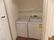 A white laundry room featuring modern washer and dryer units inside a closet with shelving at 1018 Sun Poppy Ave, Las Vegas, NV 89123