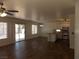 Open-concept living room with ceiling fans seamlessly connects to the kitchen and backyard at 1018 Sun Poppy Ave, Las Vegas, NV 89123
