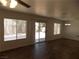 Spacious living room featuring wood floors, bright windows and access to the patio at 1018 Sun Poppy Ave, Las Vegas, NV 89123