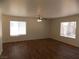 Spacious living room with wood floors, a ceiling fan, and many windows at 1018 Sun Poppy Ave, Las Vegas, NV 89123