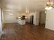 Large living room featuring a kitchen, wood floors and neutral paint at 1018 Sun Poppy Ave, Las Vegas, NV 89123