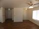 Open layout living room with wood flooring, neutral walls and ceiling fan at 1018 Sun Poppy Ave, Las Vegas, NV 89123