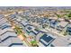 High-angle aerial view of many new homes with solar panels featuring backyard amenities at 10435 Rose Palisade St, Las Vegas, NV 89141