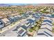 Aerial view of a community featuring many homes and desert landscaping on a sunny day at 10435 Rose Palisade St, Las Vegas, NV 89141