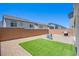 Well-kept backyard featuring patio with small dining set, artificial turf, and stainless steel grill at 10435 Rose Palisade St, Las Vegas, NV 89141