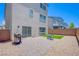 The backyard shows a patio with grill and a small dining set, complemented by synthetic grass at 10435 Rose Palisade St, Las Vegas, NV 89141