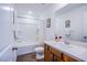 Well-lit bathroom with a bathtub/shower combination, vanity, and modern fixtures at 10435 Rose Palisade St, Las Vegas, NV 89141