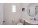 Small bathroom features a toilet, sink, vanity and framed mirror at 10435 Rose Palisade St, Las Vegas, NV 89141