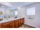 Bathroom with double sinks, granite countertops, and a glass-enclosed shower at 10435 Rose Palisade St, Las Vegas, NV 89141