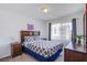 Bedroom with large window and neutral walls offers a comfortable retreat at 10435 Rose Palisade St, Las Vegas, NV 89141