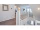 Upstairs hallway with white railing and neutral carpet throughout at 10435 Rose Palisade St, Las Vegas, NV 89141