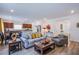 Open floorplan living room with hardwood floors, contemporary furniture, and lots of natural light at 10435 Rose Palisade St, Las Vegas, NV 89141