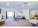 Large living area features a cozy sofa, desk, and natural light at 10435 Rose Palisade St, Las Vegas, NV 89141