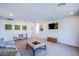 Spacious living room boasts modern lighting and a comfortable seating area at 10435 Rose Palisade St, Las Vegas, NV 89141