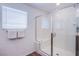 Clean shower with glass enclosure, seat, and convenient towel racks at 10435 Rose Palisade St, Las Vegas, NV 89141