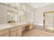 Bright bathroom with dual sinks, a soaking tub, and a glass-enclosed shower at 10548 Findlay Ave, Las Vegas, NV 89134