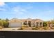 Charming single-story home featuring a well-maintained yard with desert landscaping and attached two-car garage at 10548 Findlay Ave, Las Vegas, NV 89134