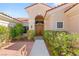 Inviting front entrance with lush desert landscaping, brick pathway, and double wood doors at 10548 Findlay Ave, Las Vegas, NV 89134