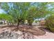 Landscaped front yard featuring mature trees and desert-friendly gravel at 10548 Findlay Ave, Las Vegas, NV 89134