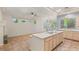 Open-concept kitchen with a large island, modern appliances, and tile flooring extending into the adjacent living area at 10548 Findlay Ave, Las Vegas, NV 89134