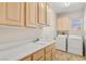 Laundry room with white cabinets, sink, and appliances at 10548 Findlay Ave, Las Vegas, NV 89134
