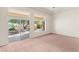 Living room with large windows and sliding door offer panoramic views of the backyard at 10548 Findlay Ave, Las Vegas, NV 89134