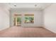 Spacious living room with plush carpet flooring, recessed lighting, and large sliding glass doors to the backyard at 10548 Findlay Ave, Las Vegas, NV 89134