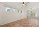 Bright living room is well-lit by modern ceiling fan and many large windows at 10548 Findlay Ave, Las Vegas, NV 89134