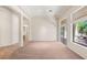 Bright living room with open layout, neutral carpet, and large windows providing natural light and outdoor views at 10548 Findlay Ave, Las Vegas, NV 89134