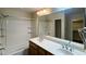 Bathroom featuring double sinks with a large mirror and a shower/tub combo with tile surround at 11404 Belmont Lake Dr # 103, Las Vegas, NV 89135