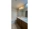 Bathroom featuring double sinks with a large mirror and a shower/tub combo with tile surround at 11404 Belmont Lake Dr # 103, Las Vegas, NV 89135