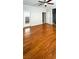 Bright bedroom featuring hardwood floors, ceiling fan, and ensuite bathroom with glass-door shower at 11404 Belmont Lake Dr # 103, Las Vegas, NV 89135