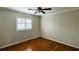 Cozy bedroom has hardwood floors, a window with white shutters, and a ceiling fan at 11404 Belmont Lake Dr # 103, Las Vegas, NV 89135