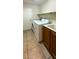 Functional laundry room with appliances, shelving, and a utility sink at 11404 Belmont Lake Dr # 103, Las Vegas, NV 89135