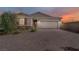 Charming single-story home featuring brick driveway, two-car garage and desert landscaping at 129 Barton Bay Ave, North Las Vegas, NV 89031