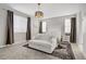 Spacious main bedroom featuring a seating area, large windows, and elegant decor for ultimate relaxation at 129 Barton Bay Ave, North Las Vegas, NV 89031