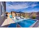 Inviting backyard pool with lounge chairs, umbrella, and shaded seating area at 129 Barton Bay Ave, North Las Vegas, NV 89031