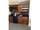 Efficient kitchenette with dark wood cabinets, mini fridge, microwave and compact countertops at 135 E Harmon Ave # 307, Las Vegas, NV 89109
