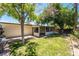 Backyard with a covered patio, mature trees, and well-maintained lawn, perfect for outdoor enjoyment at 1904 Fontenelle St, Las Vegas, NV 89102