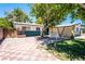Private backyard featuring a tiled patio area, mature trees, and ample space for outdoor enjoyment at 1904 Fontenelle St, Las Vegas, NV 89102