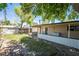 Backyard featuring a covered patio, mature trees, partial lawn, garden bed and shed at 1904 Fontenelle St, Las Vegas, NV 89102